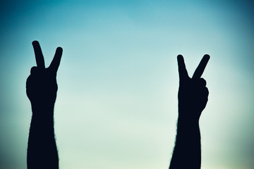 Silhouette of a team of people hands shows gesture ok