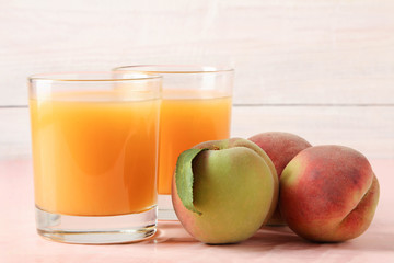 Fototapeta na wymiar Fresh juice with peaches on wooden background.