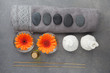 Spa massage setting with rolled towel, thai herbal compress balls and flowers. Flat lay. Top view