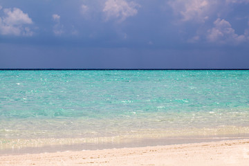 Fototapeta na wymiar Clear white sand on Maldive island coast