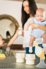 Bottle with milk and manual breast pump © petunyia