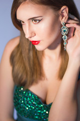 Elegant Posh Woman with Diamond Earrings. Platinum Jewelry with green Diamonds. Soft focus