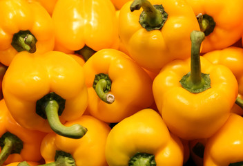 Yellow bell peppers displayed at the market