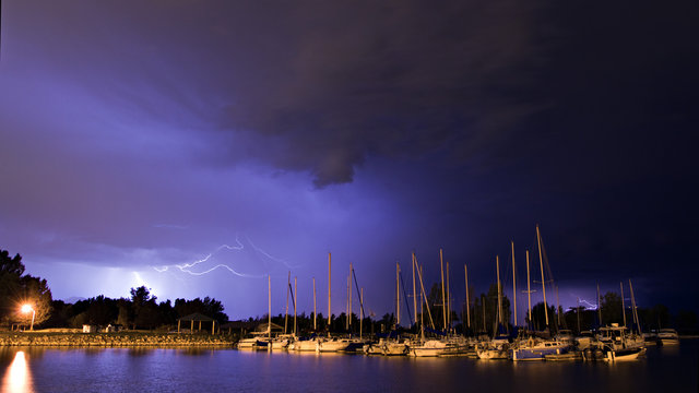 Lightning over docked boats at night