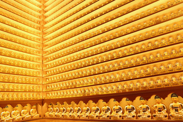 Wall full of small golden Buddha statues at the Yakchunsa (Yakcheonsa) Temple on Jeju Island in South Korea.