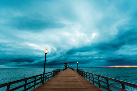 Stormy sky above pier at dusk