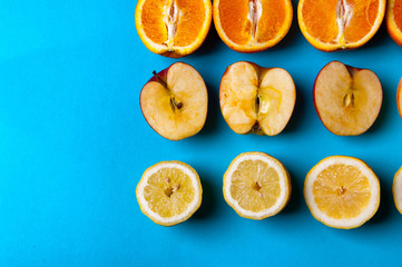 Naklejka na ściany i meble Healthy fruits on a blue background from above