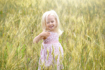 Little blonde girl in the field