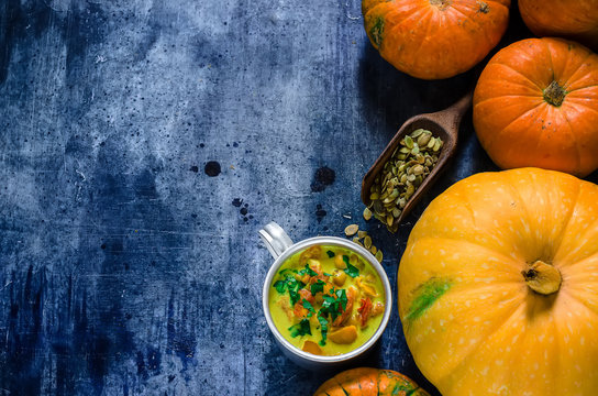  Pumpkin soup and pumpkins on blue background.