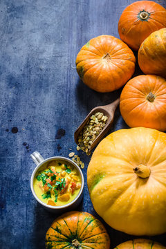  Pumpkin soup and pumpkins on blue background.