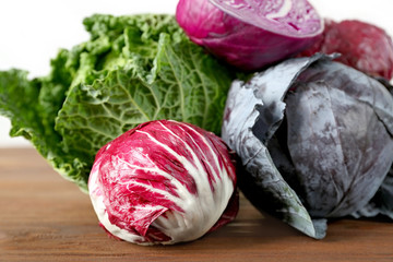 Fototapeta premium Different kinds of fresh cabbage on brick wall background