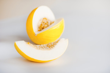 Canary melon yellow cantaloupe wedge on white background