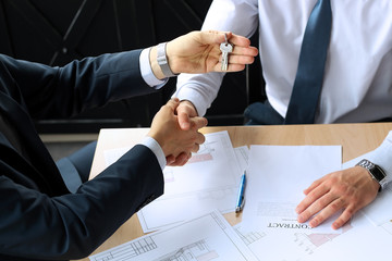 Close-up image of a firm handshake between two colleagues after