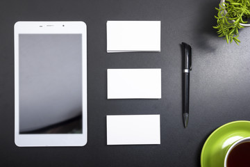 Business card blank, notepad, coffee cup and pen, flower at office desk table top view. Corporate stationery branding mock-up