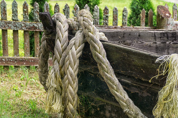 Old wooden fishing boat with rope and fishing net. Close up
