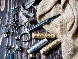 Sewing textile or cloth. Scissors reel of thread, and golden fabric.