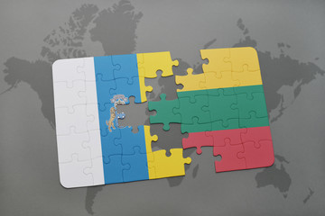 puzzle with the national flag of canary islands and lithuania on a world map background.