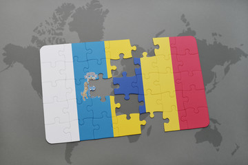 puzzle with the national flag of canary islands and romania on a world map background.
