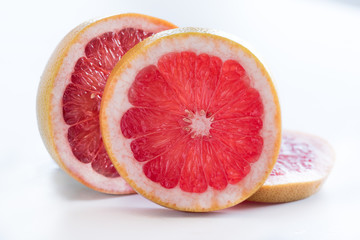 Slices of Ruby Grapefruit on white background