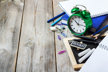 Assortment of office and school supplies on wooden table