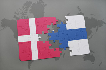 puzzle with the national flag of denmark and finland on a world map background.