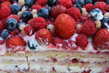 Delicious biscuit cake with fresh strawberries, raspberries, blueberries