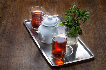 tea break consist of two cups of tea, tea pot,mint in cold water and its traditional way of serving tea in egypt. 