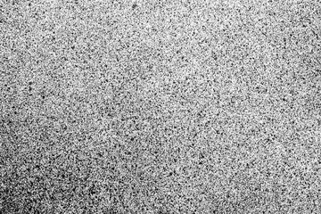 Distressed spray black paint on white surface.