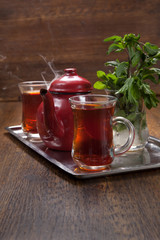 tea break consist of two cups of tea, tea pot,mint in cold water and its traditional way of serving tea in egypt. 