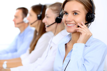 Young beautiful business woman in headset. Call center operator.