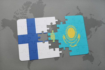 puzzle with the national flag of finland and kazakhstan on a world map background.