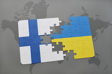 puzzle with the national flag of finland and ukraine on a world map background.