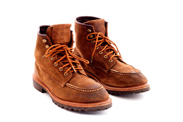 Pair of old yellow working boots Isolated on white background