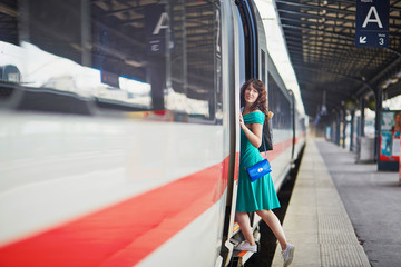 Young woman on the platform of a train station