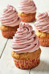 Cupcakes with pink cream, selected focus