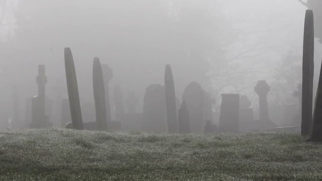 Spooky graveyard in the grounds of an old Chapel. Shot in early morning in deep mist / fog for an extra spooky feel.