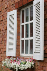 Vintage white window with red brick wall, selective focus