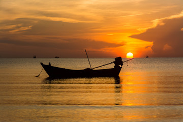 Silhouette of fishing boat at ะhe Sunrise in thailand