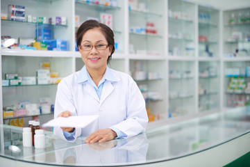 Portrait of female pharmacist giving you prescription