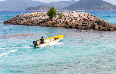 barque de p&ecirc;che quittant le port de la Digue, Seychelles 