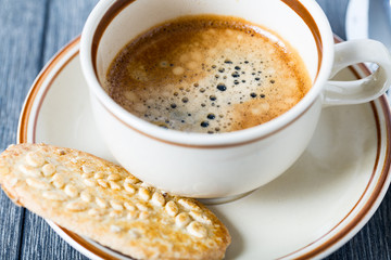 Coffee cup with espresso and cookie