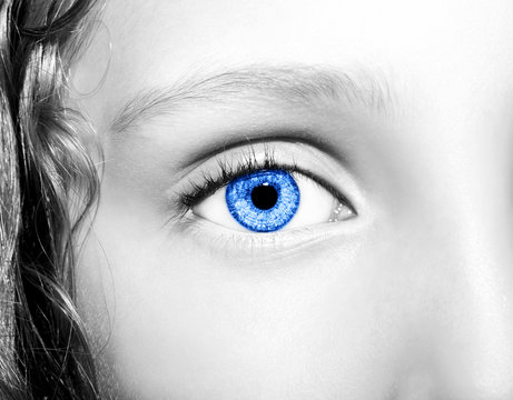 Macro Close up portrait of young girls blue eye