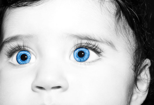 Macro Close up portrait of a cute little baby girls with big blue eyes