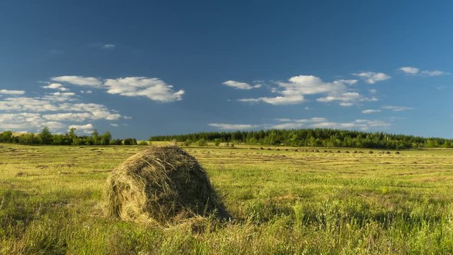 Hay harvesting stack hay farmers are preparing to float on clouds field