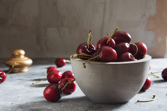 Fototapeta Fresh Cherries on a Concrete Table