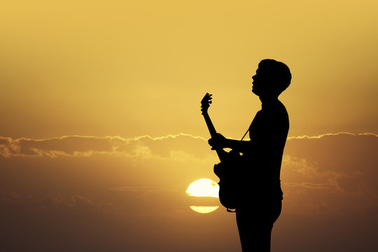 illustration of guitarist at sunset