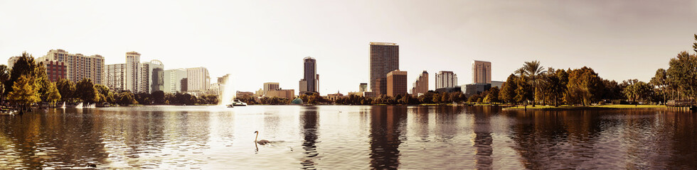 Orlando downtown Lake Eola panorama with urban buildings and reflection