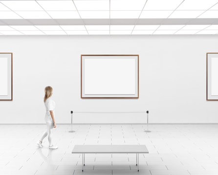 Modern gallery wall mockup. Woman walk in museum hall with blank wall with frames. White clear stand mock up show. Display artwork presentation. Art design empty floor. Expo studio wall in center.