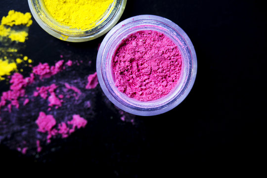 Pink  And Yellow Eye Shadow Powder Isolated On Black Background