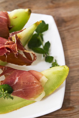 Concept of spanish food with melon and prosciutto.